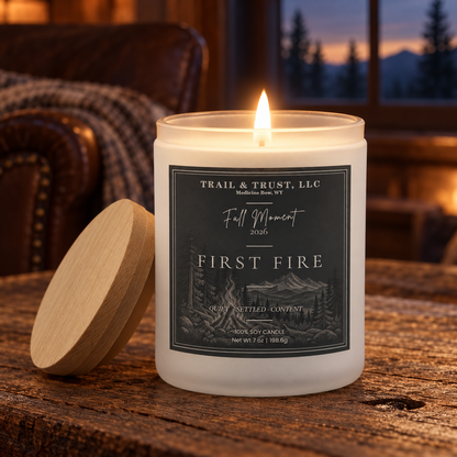 Trail & Trust First Fire candle, Fall 2026 — warm autumn lifestyle setting